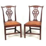 A PAIR OF GEORGE III MAHOGANY CHIPPENDALE STYLE SIDE CHAIRS with scrolled fold-over corners above