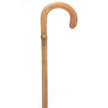 A LATE 19TH / EARLY 20TH CENTURY POSSIBLY RHINO HORN WALKING STICK with curved handle and plaited
