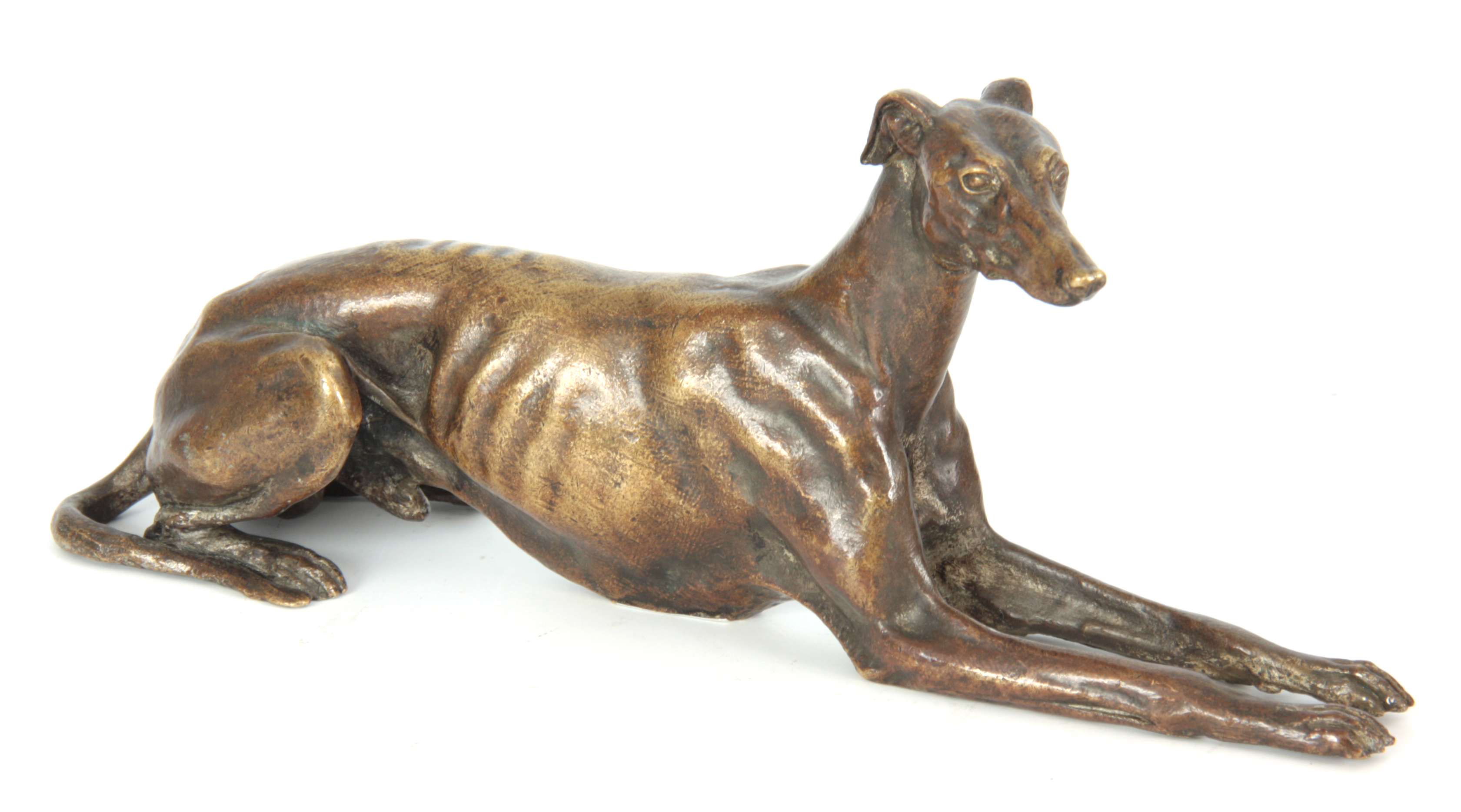 A LATE 19th CENTURY PATINATED BRONZE SCULPTURE modelled as a recumbent greyhound 26cm long