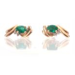 A PAIR OF LADIES 14CT GOLD EMERALD AND DIAMOND RING each set with oval cut emerald and two