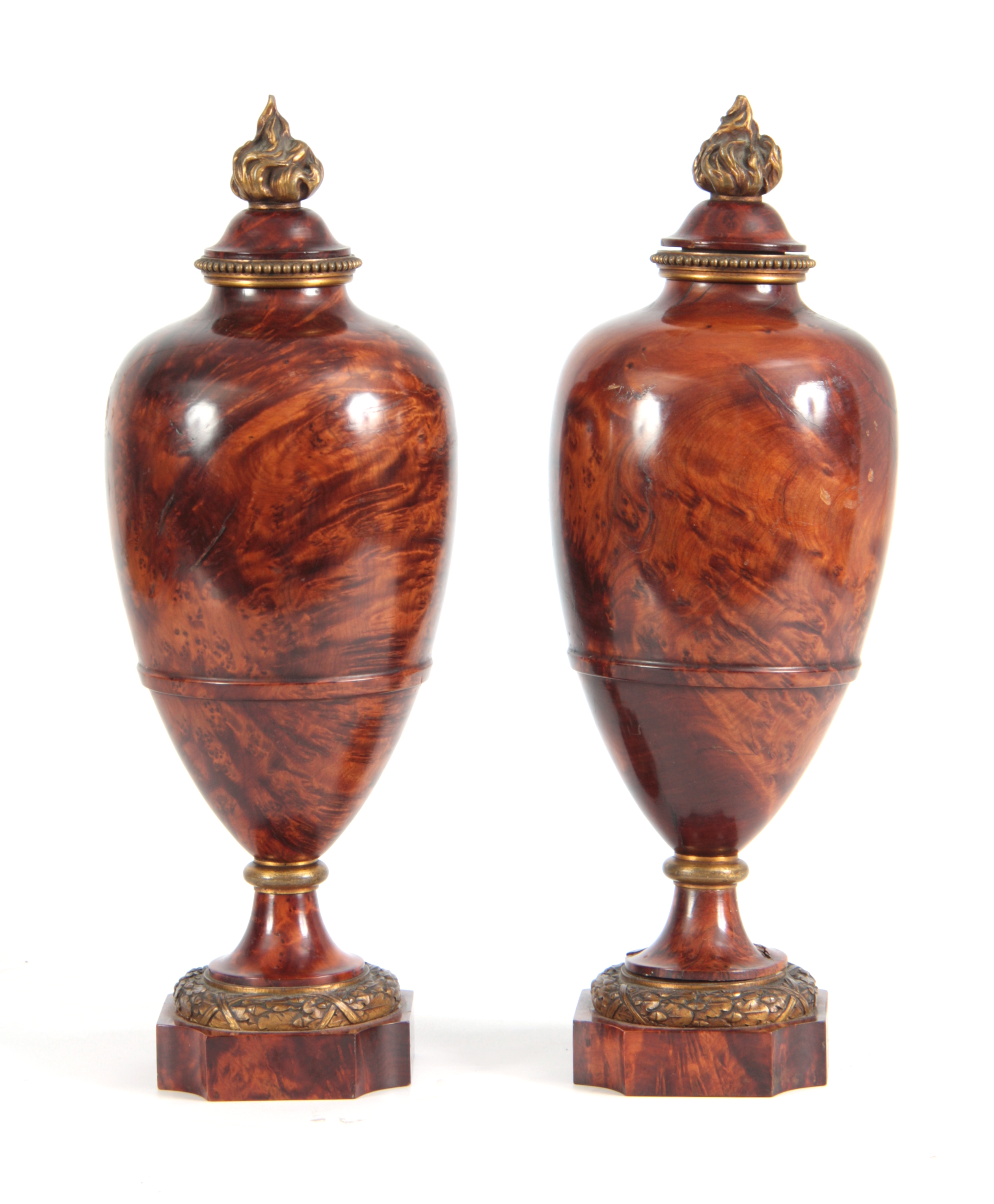 A FINE PAIR OF 19TH CENTURY BURR YEW-WOOD ORMOLU MOUNTED URNS with flame finials and bulbous