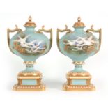 AN UNUSUAL SHAPED A PAIR OF ROYAL WORCESTER LIDDED CABINET VASES BY CHARLES BALDWYN having bulbous