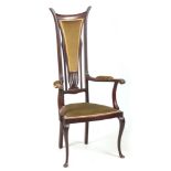 AN ART NOUVEAU MAHOGANY LIBERTY STYLE OPEN ARMCHAIR with stylised shaped back and sweeping arms;