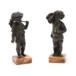 A PAIR OF 19th CENTURY PATINATED BRONZE SCULPTURES modelled as putti harvesters mounted on Sienna