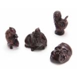 A COLLECTION OF FOUR EARLY 20th CENTURY NETSUKE sculptured as various animals and figures, three