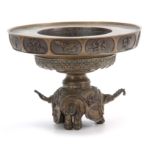 AN ORNATE 19TH CENTURY CHINESE CAST BRONZE CENSOR BASE the foot formed as three elephants heads