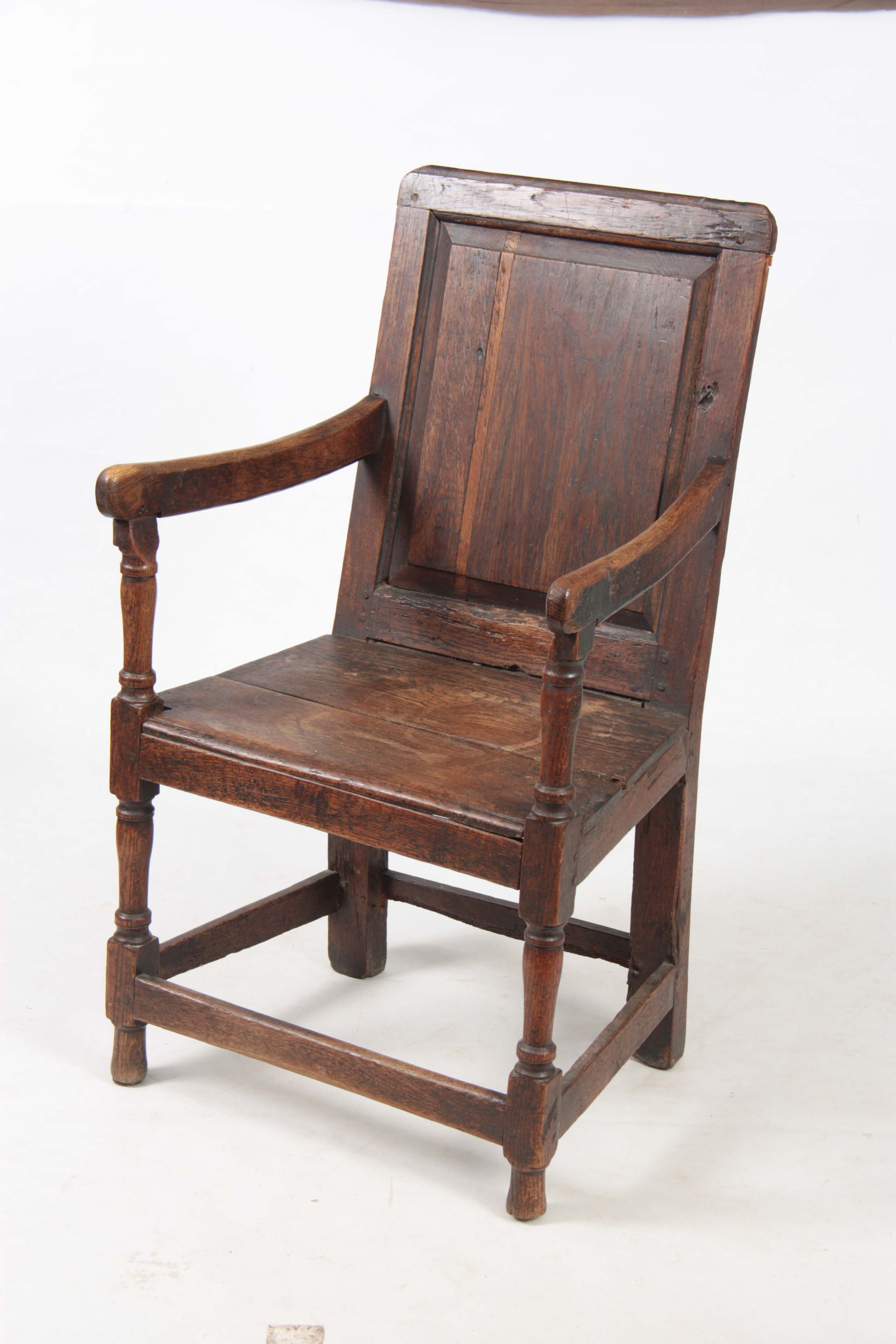 AN EARLY 18TH CENTURY OAK WAINSCOT CHAIR having fielded panel back with open arms and turned - Image 4 of 5