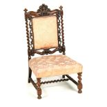 A MID VICTORIAN ROSEWOOD UPHOLSTERED ROSEWOOD NURSING CHAIR with leaf carved top rail, barley