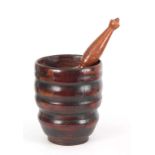 AN 18TH CENTURY YEW-WOOD PESTLE AND MORTAR of ribbed bulbous form with later Pestle 23cm high 20cm