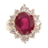 A LADIES 14ct GOLD RUBY AND DIAMOND RING having a