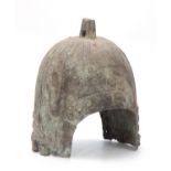 A CHINESE BRONZE HELMET, PROBABLY HAN DYNASTY 206BC- 220AD, with angular lug surmounting a ribbed