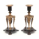 A PAIR OF REGENCY BRONZE AND ORMOLU CANDLESTICKS /