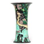 A CHINESE BLACK GROUND FLARED CYLINDRICAL VASE with overall Famille Verte decoration 33cm high