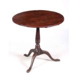 AN EARLY 18TH CENTURY YEW-WOOD AND OAK TILT TOP TABLE with circular plank top on a turned stem;