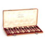 A RUSSIAN OAK FITTED CASED SET OF TWELVE SILVER AND SILVER GILT SPOONS with partly twist handles and