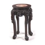A SMALL 19TH CENTURY PROFUSELY CARVED CHINESE HARDWOOD CIRCULAR JARDINIERE STAND with marble inset