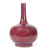 AN 18th CENTURY FLAMBE GLAZED CHINESE BOTTLE VASE covered in a rich flambé glaze of dark purple