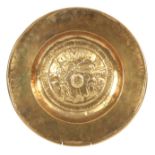 A 17TH/18TH CENTURY DUTCH BRASS ALMS DISH with punched decoration to the border and embossed
