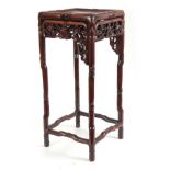 A SMALL 19TH CENTURY CHINESE HARDWOOD PLANT STAND of simulated bamboo design with pierced floral