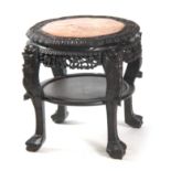 A 19TH CENTURY CHINESE HARDWOOD CIRCULAR JARDINIERE STAND with floral carved pierced frame and inset
