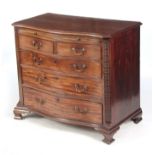 A GEORGE III MAHOGANY SERPENTINE CHEST OF DRAWERS the moulded edge top with brushing slide above two