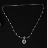 AN 18CT WHITE GOLD SAPPHIRE AND DIAMOND PENDANT NECKLACE set with 23 modern brilliant-cut diamonds