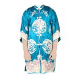 A CHINESE BLUE SILK AND FINELY EMBROIDERED KIMONO with dragon and floral panels above an overlapping