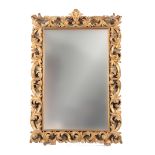 AN ORNATE 18TH/19TH CENTURY CONTINENTAL GILT HIGHLIGHTED CREAM ROCOCO MIRROR with heavy relief