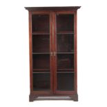 A GEORGE III IRISH CHIPPENDALE STYLE MAHOGANY DISPLAY CABINET having a carved overhanging floral