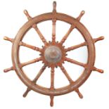 A 19TH CENTURY GIANT-SIZED OAK AND BRASS MOUNTED SHIP'S WHEEL with ten ring turned fluted spokes