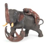 A JAPANESE MEIJI PERIOD PATINATED AND COLD PAINTED BRONZE SCULPTURE modelled as an elephant fighting