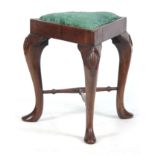 AN UNUSUAL 18TH CENTURY WALNUT TRIANGULAR STOOL with drop-in seat; standing on narrow cabriole