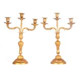 A PAIR OF 19TH CENTURY ORMOLU THREE BRANCH CANDELABRA with twisted rococo style stems on circular