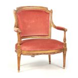 A 19TH CENTURY LOUIS XVI STYLE GILT GESSO CARVED OPEN ARMCHAIR OF GENEROUS PROPORTIONS with sweeping