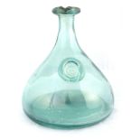 A LARGE BOTTLE GREEN GLASS CARAFE with tapering broad-based raised body and monogrammed seal 22cm
