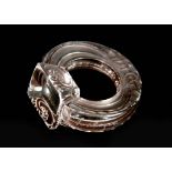 RENE LALIQUE. A DARK TINTED FROSTED AND POLISHED GLASS SEAL formed as a hoop with stylised snakes,