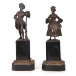A PAIR OF 19TH CENTURY BRONZE FIGURES depicting a solider and a young lady mounted on chamfered