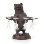 A 19TH CENTURY BLACK FORREST CARVING OF A BEAR modeled standing with arms outstretched holding a