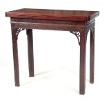 A GEORGE III MAHOGANY CARD TABLE with overhanging top revealing a green baize playing surface