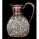 A GEORGE V LOZENGE AND FLOWERHEAD CUT GLASS CLARET DECANTER with lidded ribbed Silver neck mount,