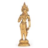 A TIBETAN STANDING GILT BRONZE FIGURE OF A BUDDHIST GODDESS 26.5cm high