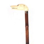 A 19TH CENTURY IVORY CARVED DOGS HEAD HANDLE WALKING CANE depicting a Greyhound with inset glass