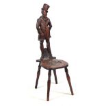 A CARVED OAK FIGURAL CHAIR OF CHARLES DICKENS INTEREST the backrest carved as Mr Micawber, the