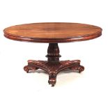 A LARGE GEORGE IV ROSEWOOD CENTRE TABLE / DINING ROOM TABLE with a figured circular top having an