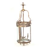 A LARGE 20TH CENTURY BRASS HANGING LANTERN with swag work pierced frieze above glazed bowed glasses,