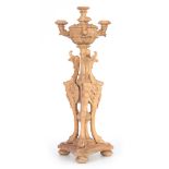 A 19TH CENTURY LIMEWOOD CANDLARBRA having gryphon shaped mounted stem below a three-branch top