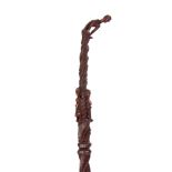 AN AFRICAN TRIBAL WALKING STICK with twisted shaft and figural carvings to the centre and handle