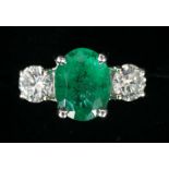 A PLATINUM, EMERALD AND DIAMOND THREE STONE RING the emerald 2.37cts and diamond weight 92 points,