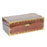 A REGENCY BRASS INLAID FLAMED MAHOGANY WRITING SLOPE having wavey edging, the angled hinged