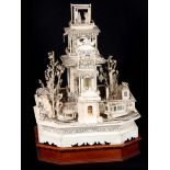A 19TH CENTURY CHINESE CARVED IVORY MODEL OF A PALACE extravagantly carved with a central three-tier